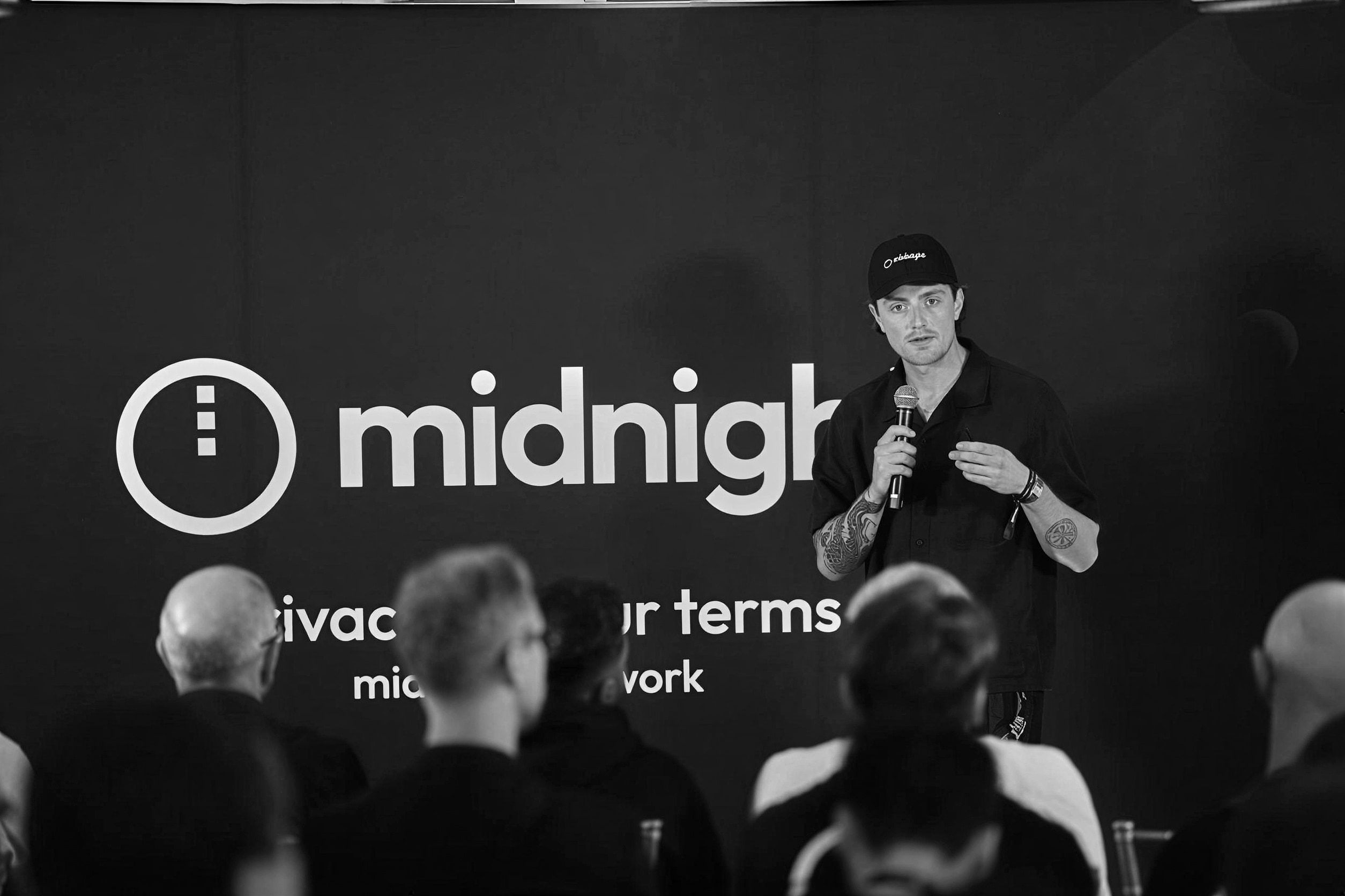 Tom presenting on stage at a Midnight event